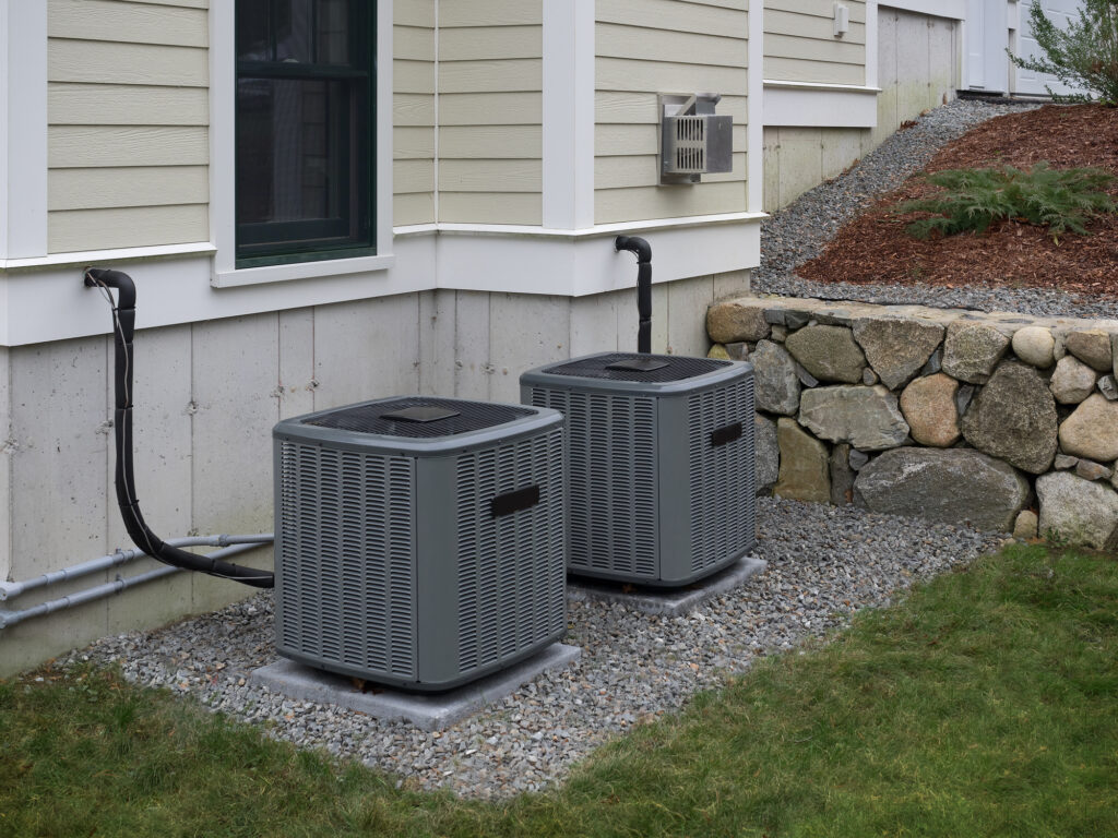 Heating and air conditioning units used to heat and cool a house sitting on a concrete slab next to a house in Mokena.
