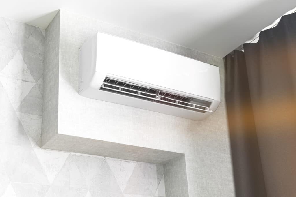 Ductless mini-split system on white wall in living room.
