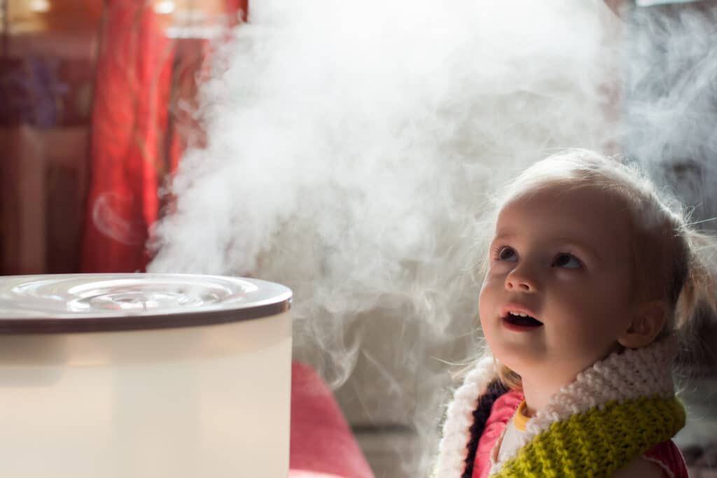 Child looking at home humidifier